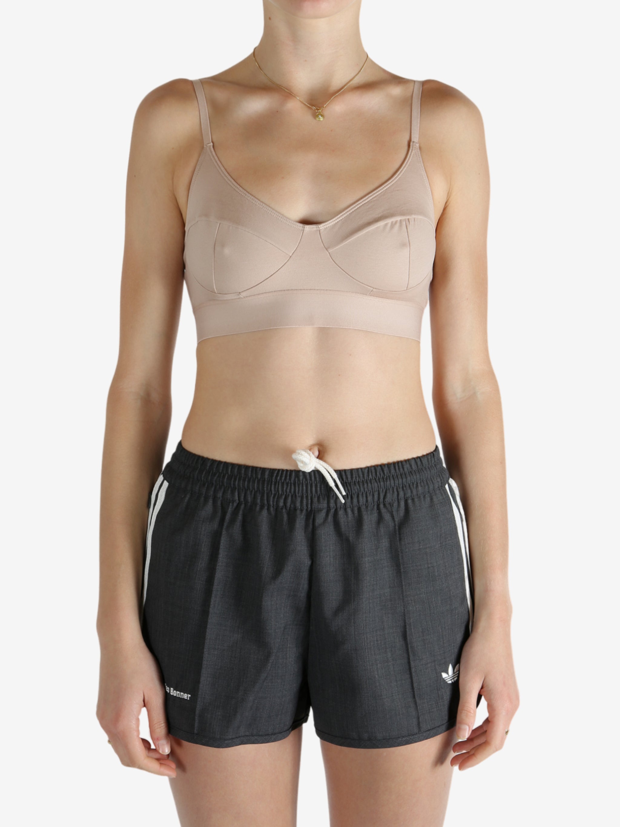 Tan top worn by a person, showing the top's fit