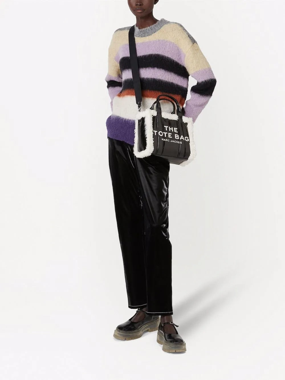 Black bag carried by a person, showing the bag's fit