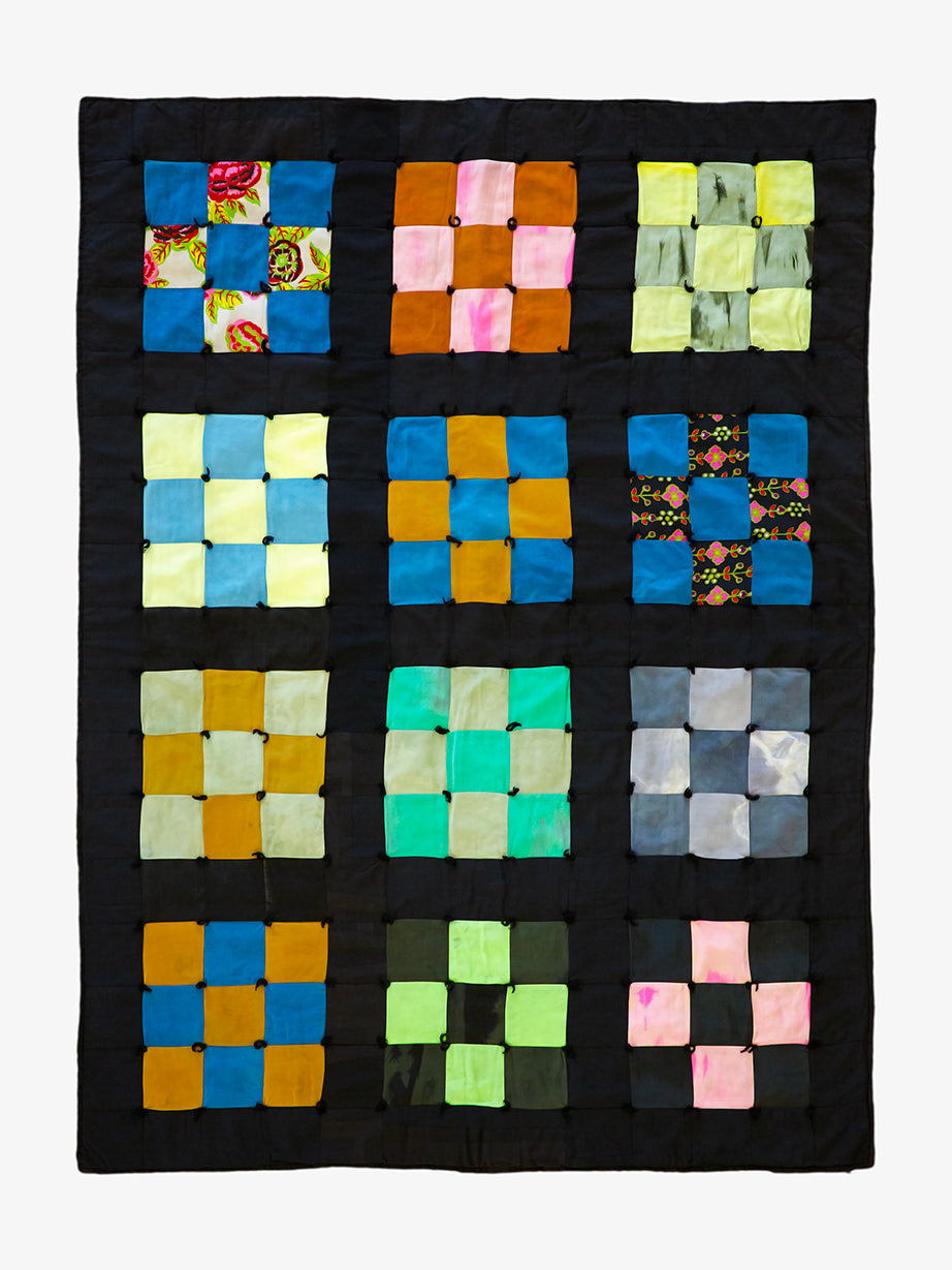 Granny Square quilt with bright multicolor patchwork on black, handmade by Lily Raskind.