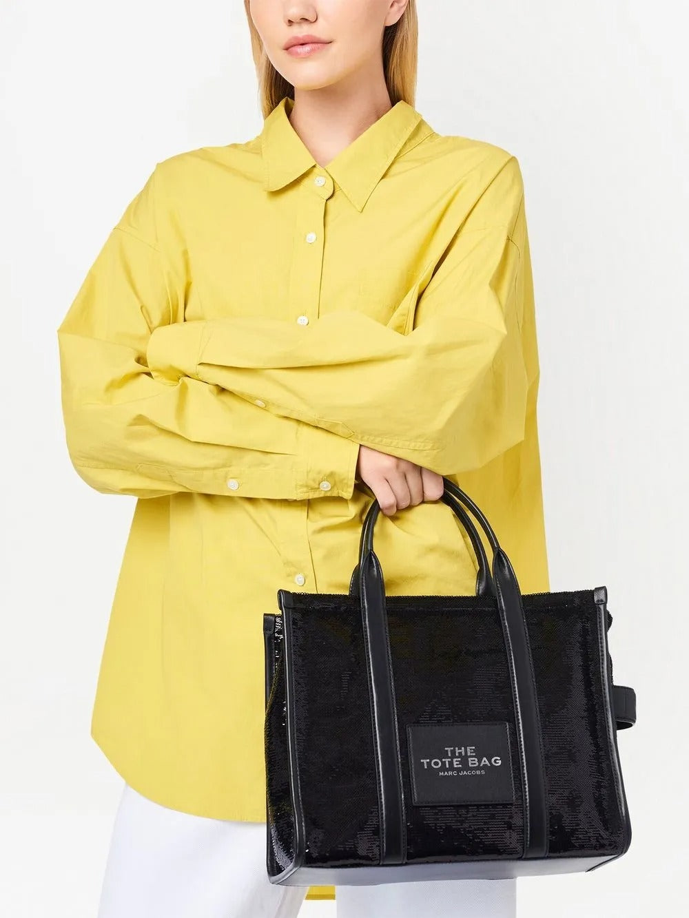 Black bag carried by a person, showing the bag's fit