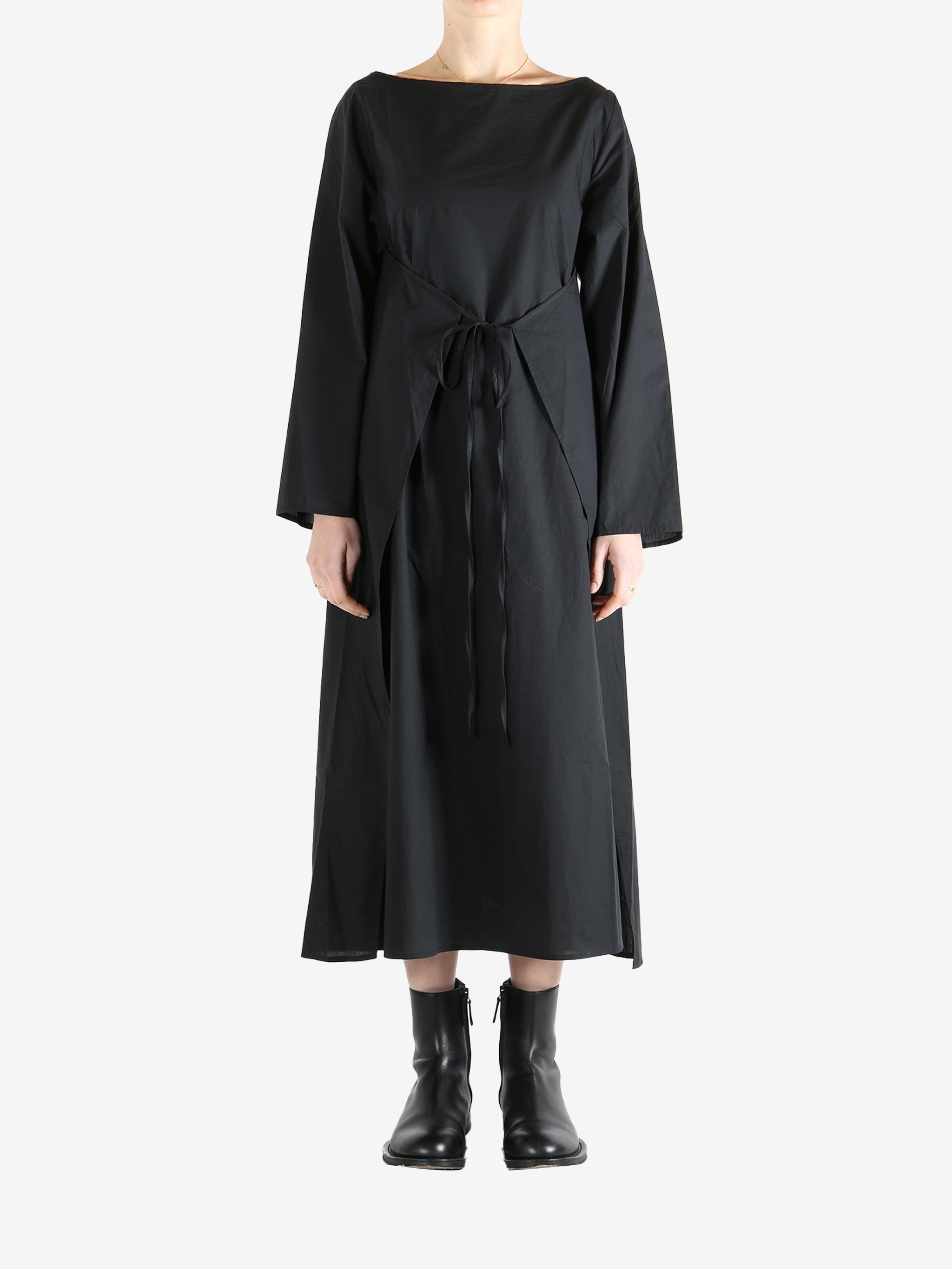 Black dresses worn by a person, showing the dresses fit