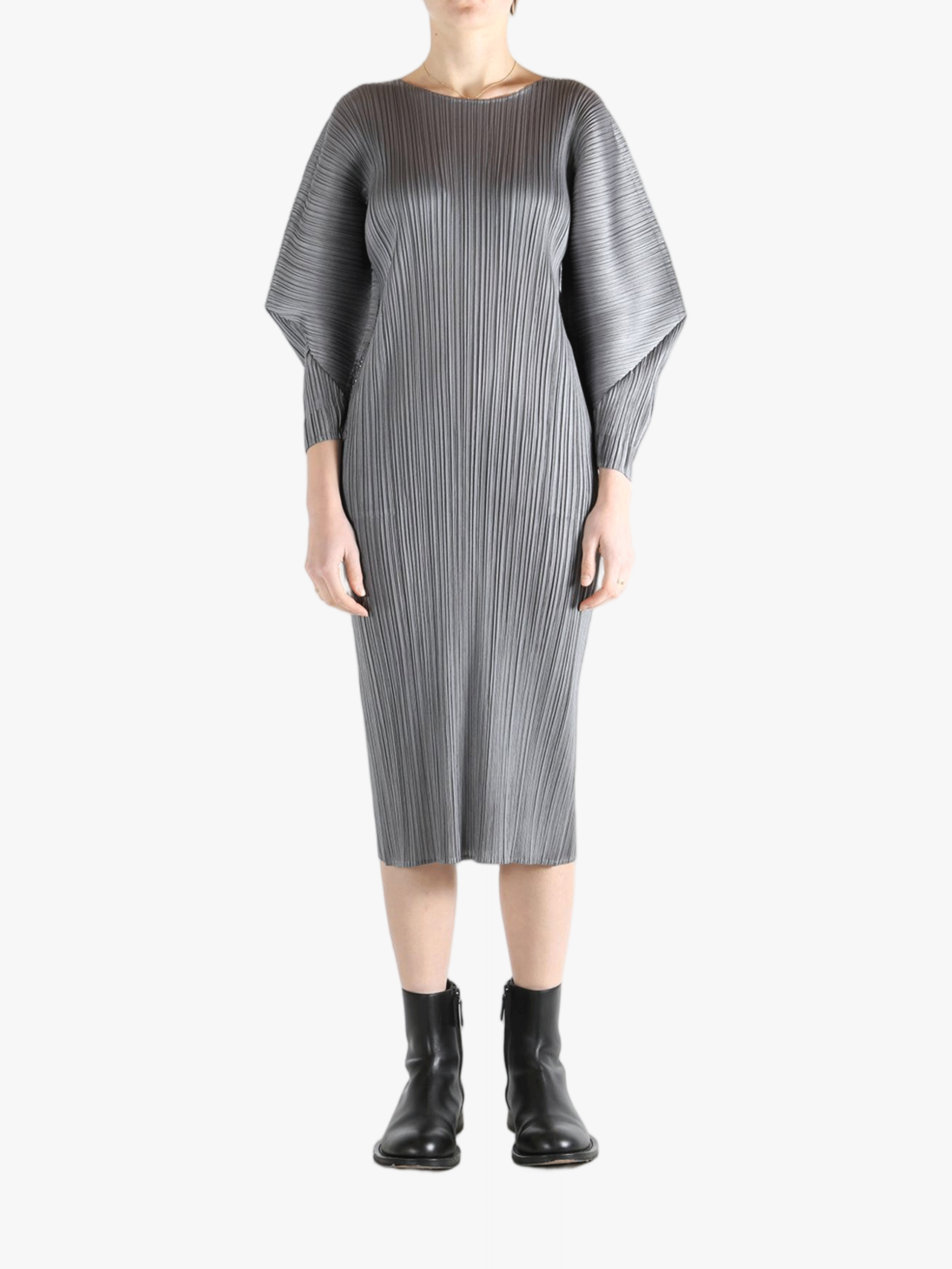 Grey dress worn by a person, showing the dress's fit