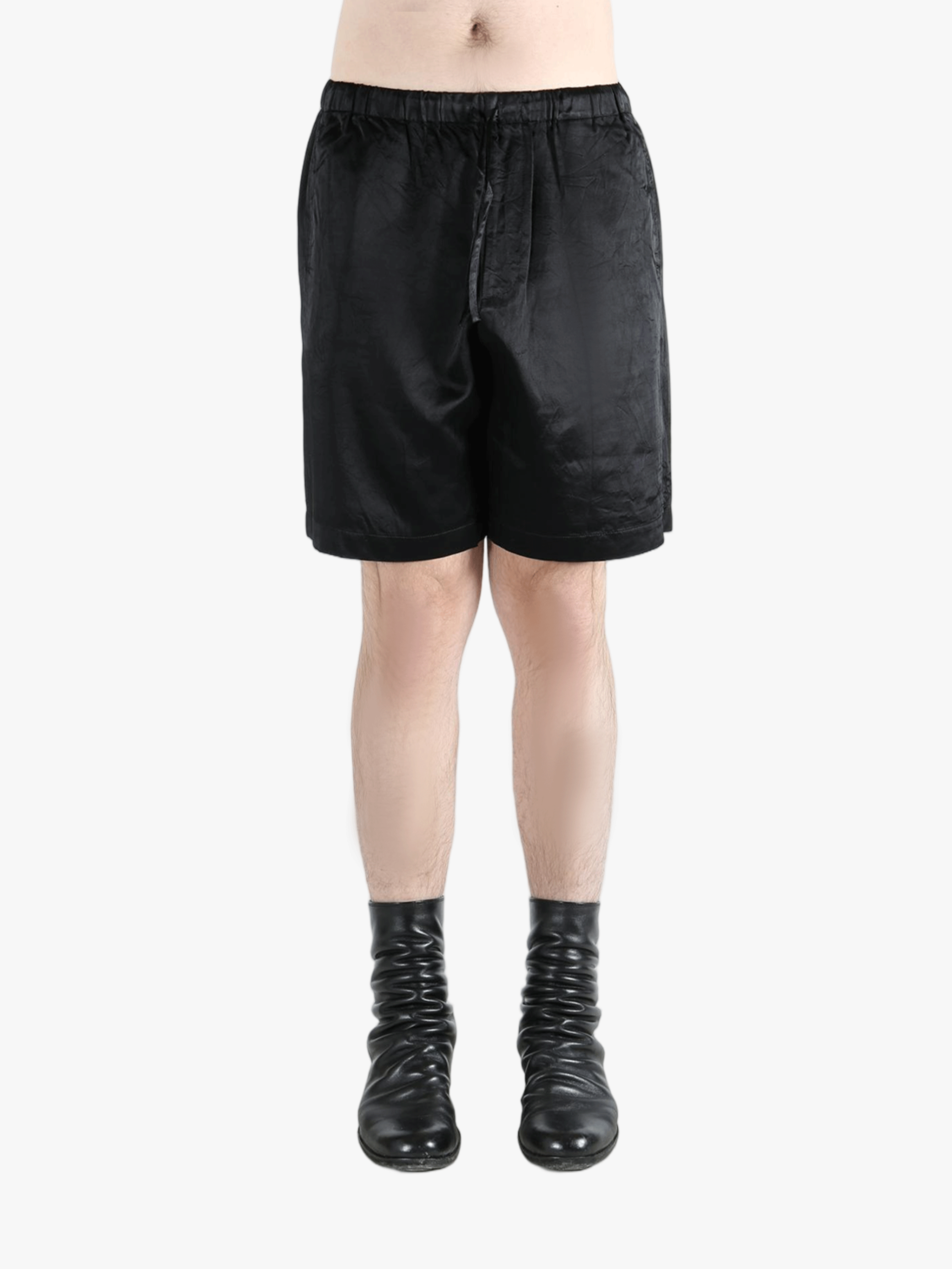 black pants worn by a person, showing the pants fit