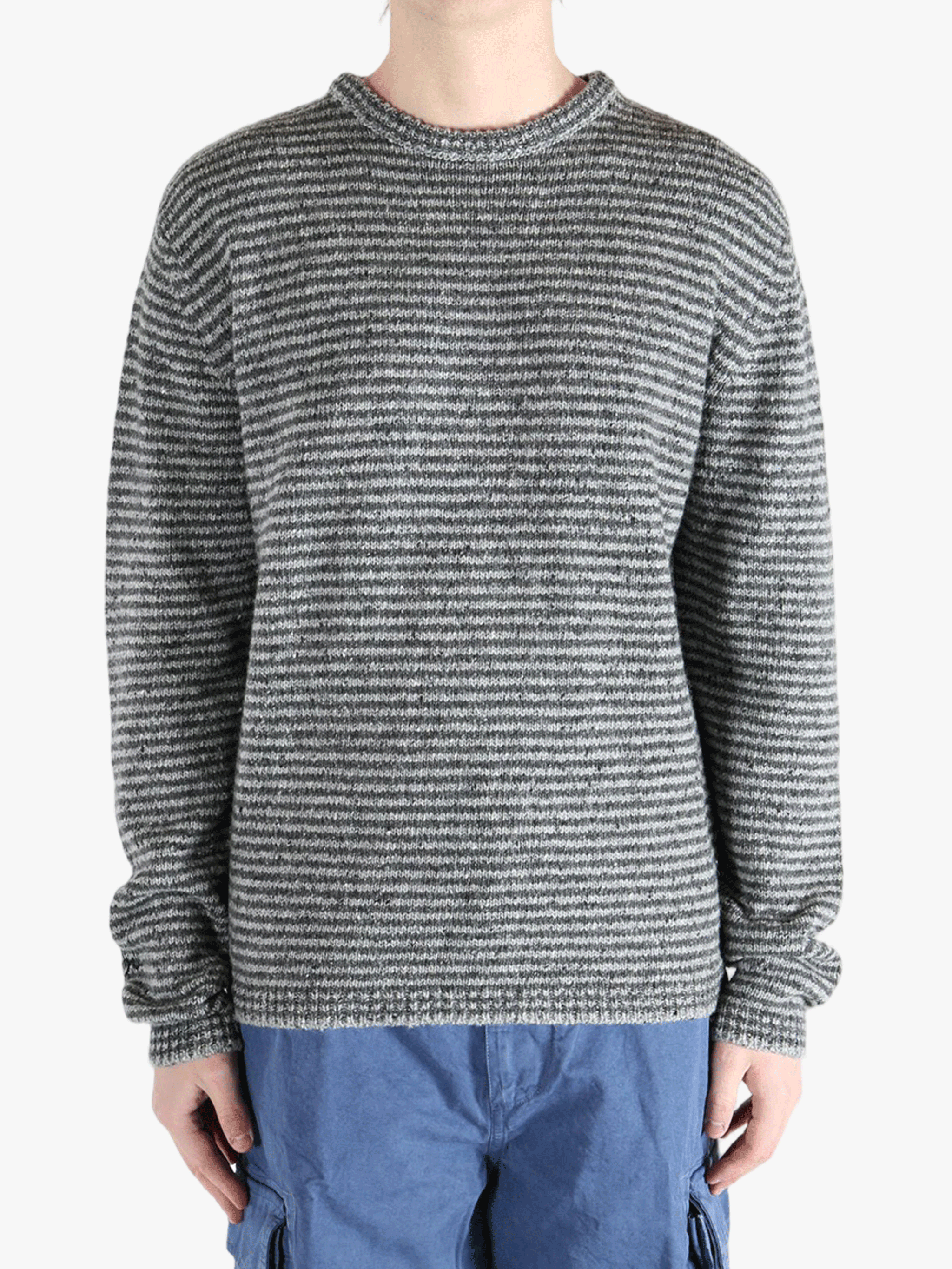 Grey knitwear worn by a person, showing the knitwear fit