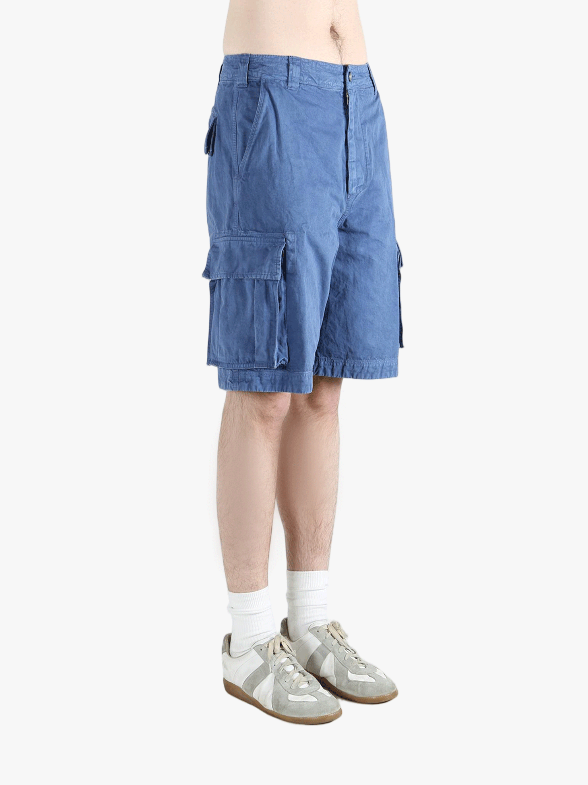 Blue shorts worn by a person,showing texture of the cotton fabric.