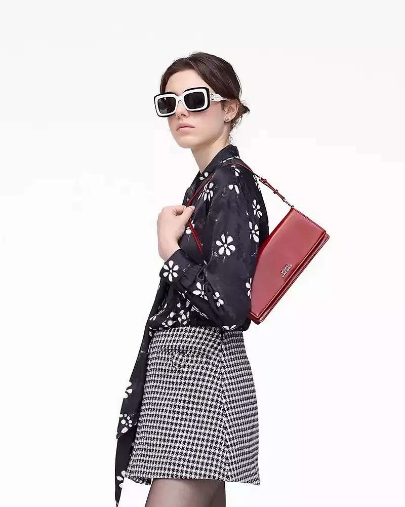 Red bag worn by a person, showing the bag's fit