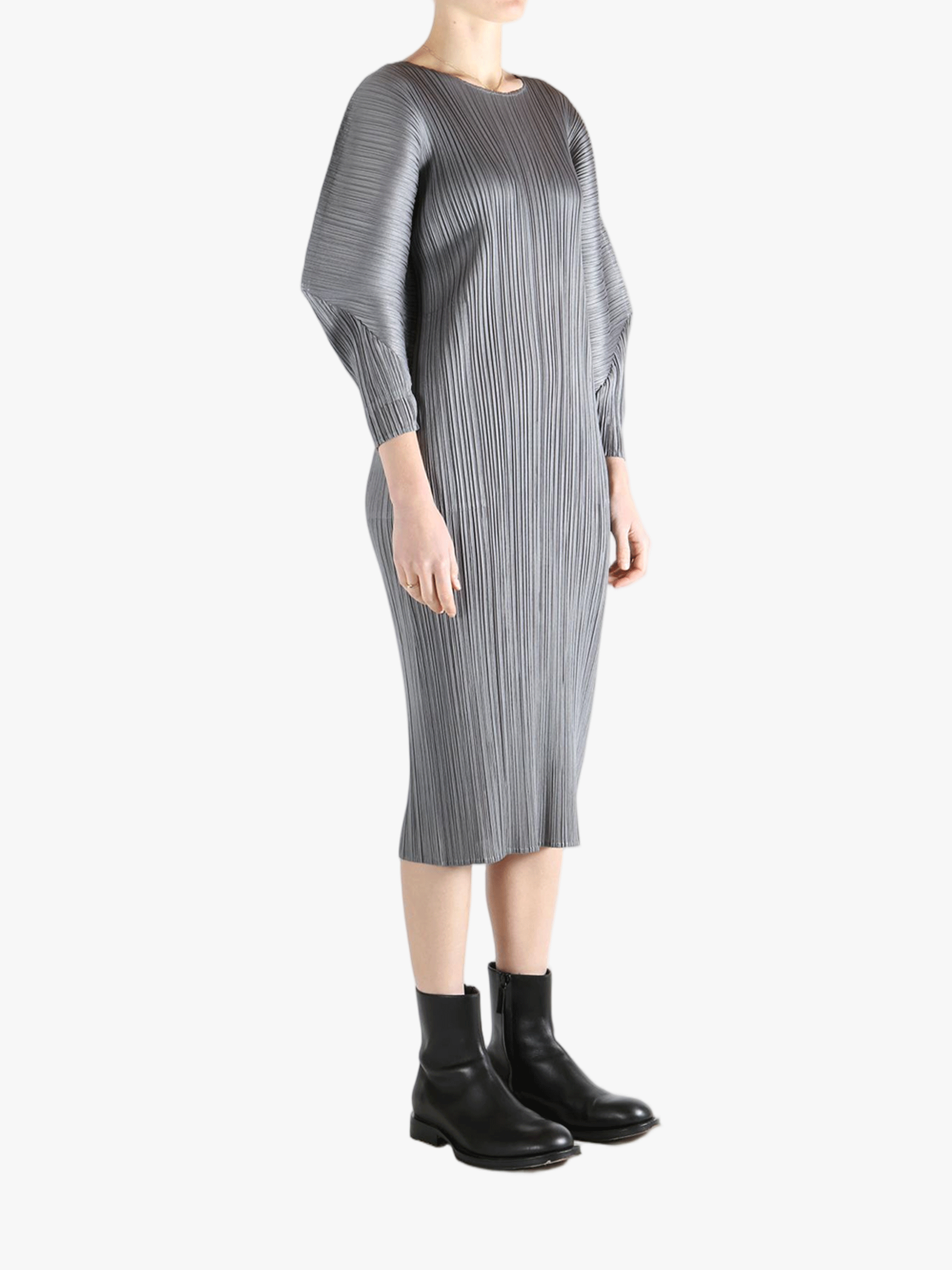 Grey dress worn by a person, showing the dress's fit